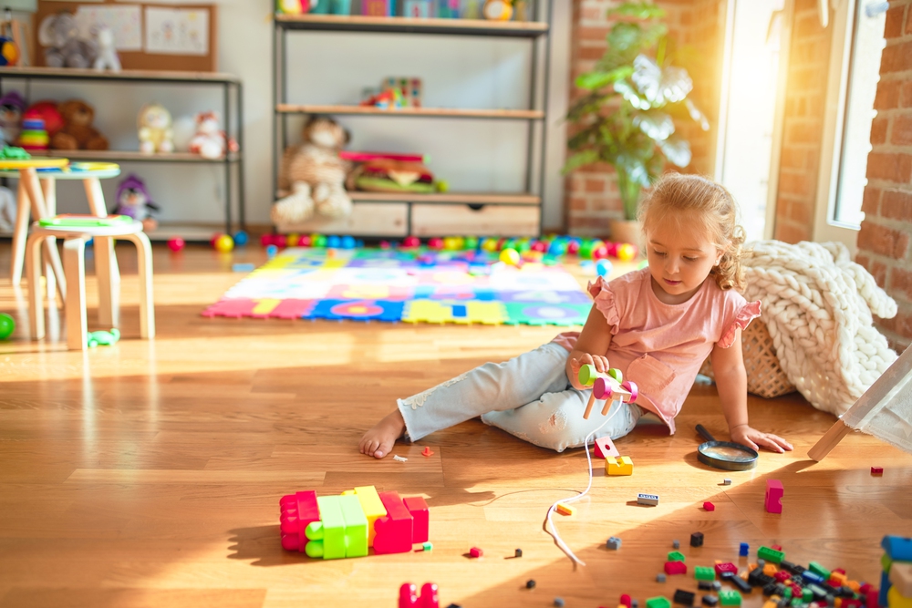 Children playing near their children's playroom furniture.