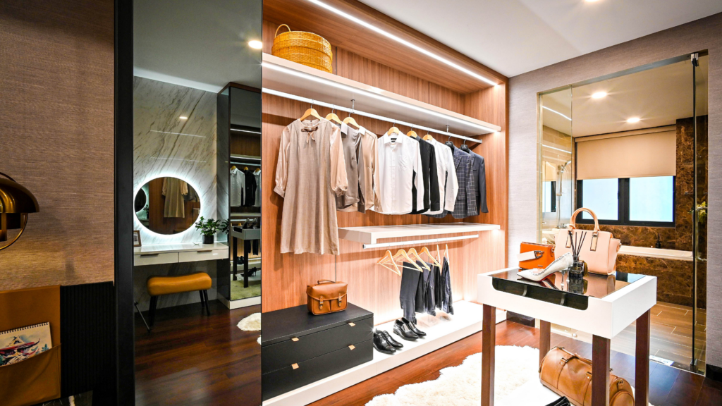 Luxurious wood-finished walk-in closet with integrated lighting, open shelving, and a vanity mirror.